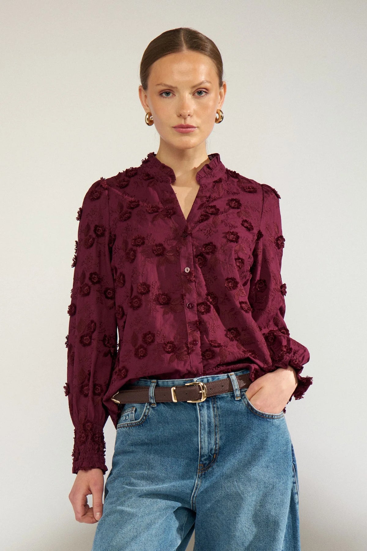 The Nümph Nulenea Shirt in Fig&nbsp;is a beautifully feminine blouse with delicate detailing and a romantic, textured finish. Crafted in a soft, sheer fabric, it features an intricate all-over floral embroidery and 3D floral appliqué design