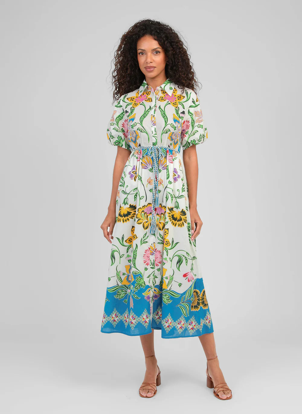 A true statement piece, this stunning shirt dress from An'ge combines effortless sophistication with vibrant colour. Designed with a classic button-through front and a flattering plaited belt, it creates a beautifully feminine silhouette while remaining comfortable and easy to wear.