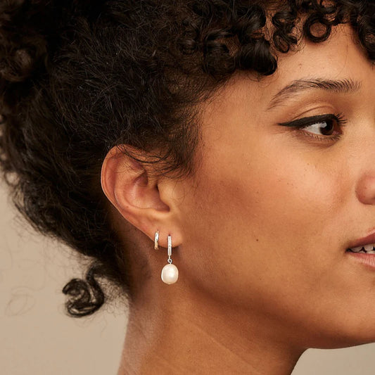 Our favourite pearl trend with a twist, these Pearl Drop Pave Huggie Hoop Earrings from ORELIA LONDON are the updated version of the classic. These delicate huggies feature a freshwater pearl charm attached to an easy to wear pave encrusted silver huggie hoop earring. Please note, earrings are non-returnable unless faulty.