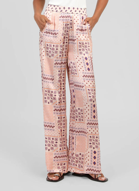 Make a statement in the effortlessly chic Presley Trousers from An'ge. Crafted in a silky-feel fabric that drapes beautifully, these striking wide-leg trousers combine comfort and style in equal measure. The vibrant print features a soft blush background adorned with eye-catching shades of orange, pink and purply blue, creating a look that is both bold and feminine.