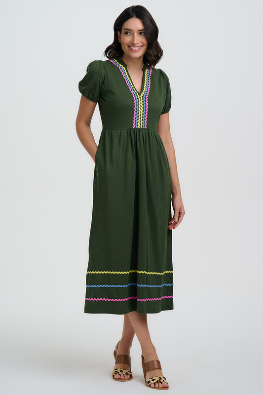 A beautiful day dress by SUGARHILL our favourite British Brand. Midi length with a notch neck this 100% organic cotton piece has the perfect amount of stretch. A slightly puffed sleev and side seam pockets and ric-rac on the neckline and hem add that extra something we expect from this Brand.