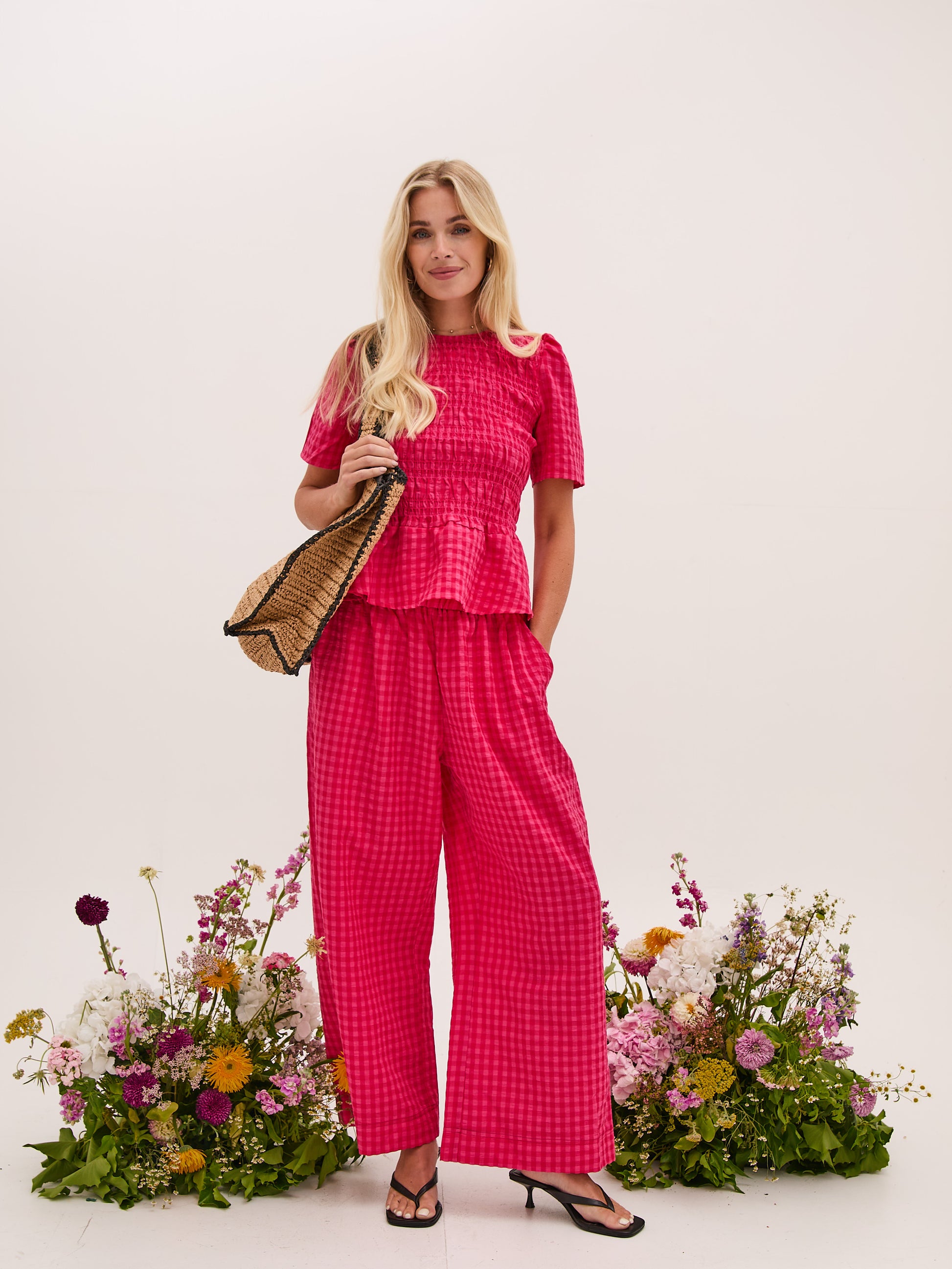 A vibrant pink gingham check pull on culotte from FIKA. These trousers have a deep elasticated waist and side pockets. The flattering wide leg is perfect for warmer weather. team with a T shirt or the matching blouse. The fit is true to size.