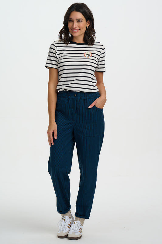 Bring bold colour into your everyday wardrobe with the Rowan Trousers from SUGARHILL – a perfect mix of style and comfort. Designed with a fully elasticated waistband for a relaxed fit, these trousers feature tapered legs that flatter the silhouette and large front patch pockets for a laid-back, practical touch. Narrow vertical navy and teal stripes create a clean, modern, and subtly textured pattern, while the option to roll up the hems makes them a versatile choice for casual dressing.