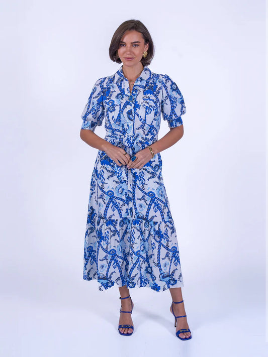 A beautiful shirt style dress from British brand NEW DAY ORIGINAL. The perfect occassion dress in a beautiful china blue print fabric. A bitton front oiece with self tie belt and pockets that exudes class. Wear to a wedding or the races dressed up or casually with your favourite trainer.