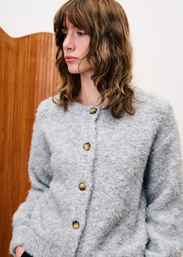 A stunning long sleeved cardigan in a beautiful boucle fabric from Parisian brand FRNCH. This cool piece can be worn on it's own or with layers underneath. A standard length style piece with a statement shoulder. The fit is true to size.