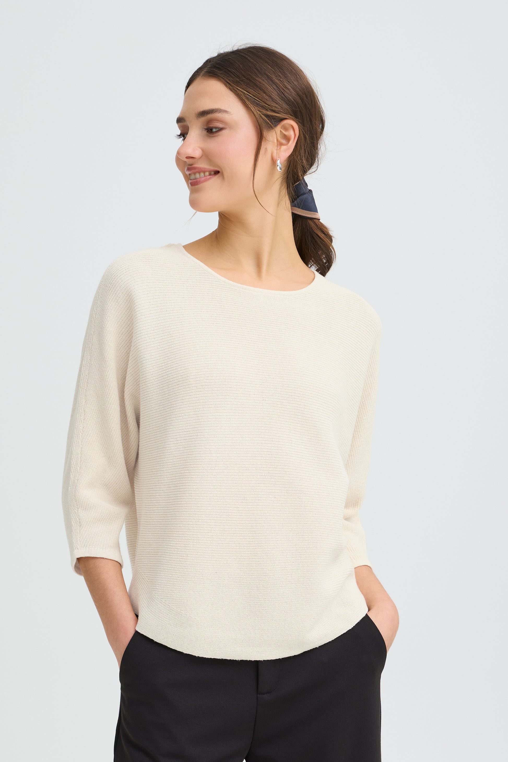 A fab little knit from Scandi brand FRANSA in a horizontal ribbed fabric. The three quarter sleeve sits at a flattering length. The knit stops at hip level and has a scooped hem and slightly batwing sleeves. A great all rounder in a neutral or a bright colour.