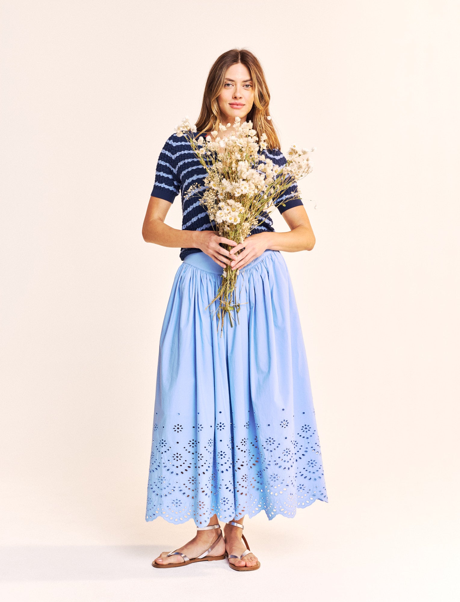 Another stunning piece from our new brand One Collective. A midi length skirt with a zip and single button to fasten at the back. In a beautiful cotton poplin fabric and half lined this piece is perfect for the Summer weather. The broderie Anglais at the hem adds a touch of class.