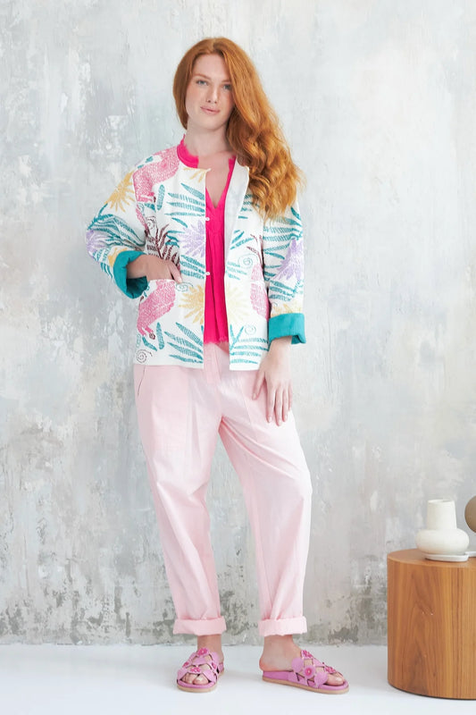 This beautiful jacket from French brand Chico Soleil has a white background and multi coloured exotic embroidering adding a touch of colour and originality. The fastening consists of flower shaped buttons and hooped threads. There is a round neck and straight hem with small rounded side splits. The pockets are at the front. A great piece for a wedding over a simple self coloured dress. Contrast coloured lining on the inside of the cuffs.