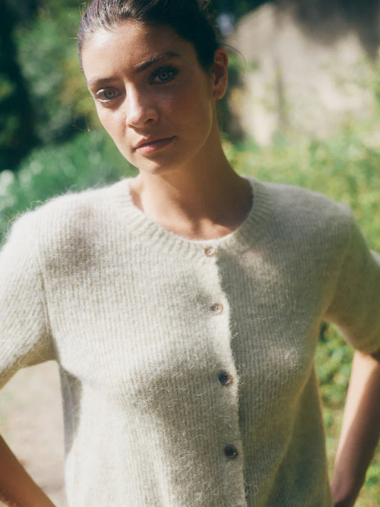A soft short-sleeved cardigan from MOS MOSH crafted from a luxurious wool and alpaca blend. Designed with a round neckline, button closure, and a clean, regular fit. Perfect for layering over dresses or tees when you want a touch of effortless sophistication. The fit is true to size.