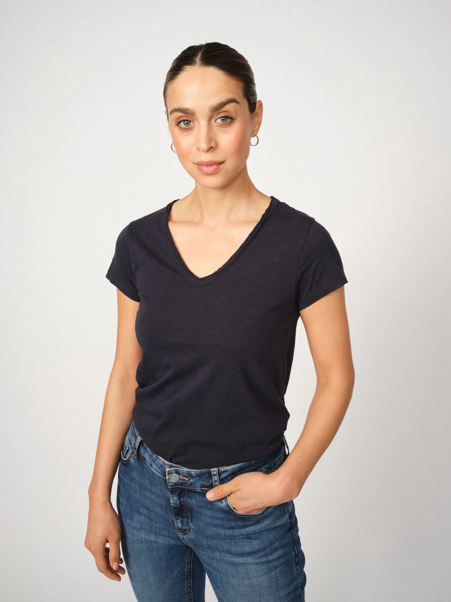 A timeless wardrobe staple from MOS MOSH, this fitted V-neck T-shirt is crafted from soft organic cotton for everyday comfort. Designed with short sleeves and a flattering silhouette, it’s perfect for layering or wearing on its own. A versatile essential that pairs effortlessly with everything from denim to tailored pieces.