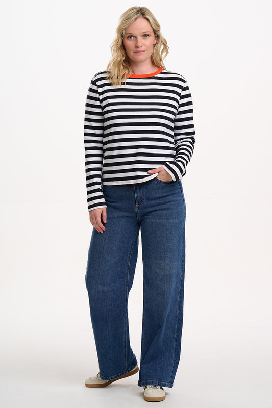 Elevate your everyday style with the Vienna Jersey Top from SUGARHILL in White and Black Stripes. This classic long-sleeve Breton top features bold horizontal stripes on soft jersey fabric, finished with a statement contrast neckline in vibrant orange for a playful twist. The relaxed fit and crew neck make it an effortless layering piece for jeans, skirts, or under dungarees—perfect for casual days and weekend wear.