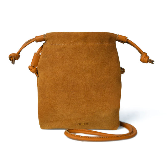 Fastened with a knotted drawstring detail which softly gather the leather creating a crossbody bag that is big enough for your phone and daily essentials. Hand made in our super soft tan suede leather, with caramel leather strap, our Willow drawstring bag is gorgeously soft, effortlessly stylish and perfectly practical.